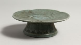 A SMALL CHINESE CELADON PEDESTAL DISH. 5ins diameter