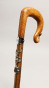 A SCOTTISH WALKING STICK with thistle handle and mounted with emblems. 40ins long.