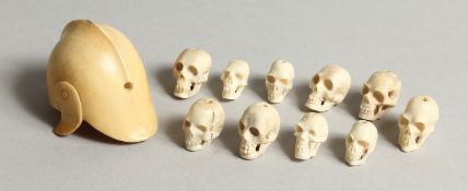 A MINIATURE CARVED IVORY MODEL OF A ROMAN HELMET and a collection of miniature bone skulls Helmet