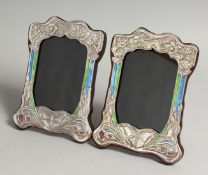 A PAIR OF SILVER AND ENAMEL BUTTERFLY PHOTOGRAPH FRAMES 8ins x 5.5ins