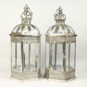 A PAIR OF SILVERED METAL AND GLASS HEXAGONAL LANTERNS 24ins high.