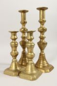 TWO PAIRS OF BRASS CANDLESTICKS 7.5ins & 12ins high.