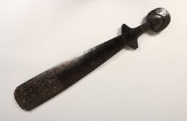 A 19TH CENTURY NEW GUINEA CARVED WOOD PADDLE 2ft 6ins long.