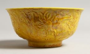A YELLOW CHINESE CIRCULAR BOWL the side with dragon in relief