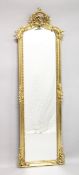 A TALL NARROW GILT FRAMED DRESSING MIRROR. 5ft 10ins high x 1ft 10ins wide.