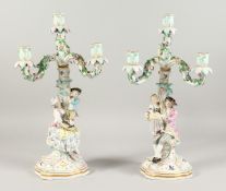 A GOOD PAIR OF 19TH CENTURY MEISSEN THREE BRANCH CANDELABRA with figures, encrusted with flowers and