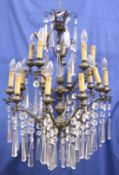 A SMALL WROUGHT IRON AND CUT GLASS CHANDELIER.