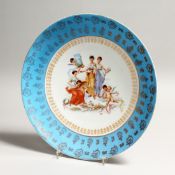 A CONTINENTAL PORCELAIN DISH, the centre decorated with female figures and cherubs, in a pale bue