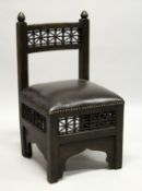 A SMALL ISLAMIC DESIGN ARMCHAIR, with mashrabiya panels, overstuffed seat on square legs.