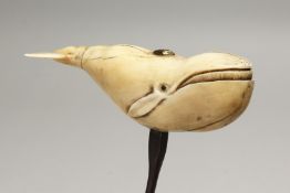 A VICTORIAN CARVED IVORY CORK SCREW, carved as a whale. 4.5ins long.