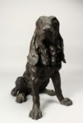 A BRONZE SEATED DOG 14ins high