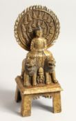 A TIBETAN GILT BRONZE SHRINE seated on two figures, the back with caligraaphy. 11ins high.