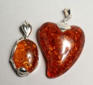 TWO SILVER AND AMBER PENDANTS
