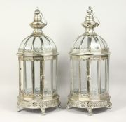 A PAIR OF SILVERED METAL AND GLASS LANTERNS 24ins high.