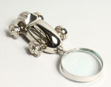 A NOVELTY MAGNIFYING GLASS the handle as a racing car.