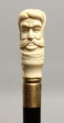 A WALKING STICK with bone HEAD handle 36ins long.