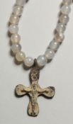 A SMALL ROMAN IRON CROSS AND BEADS.