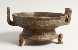 A SMALL CHINESE ARCHAIC BRONZE TWO HANDLED CENSER on three animal legs. 8ins diameter.