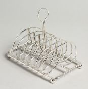 MATTHEW BOULTON. A SILVER SIX DIVISION TOAST RACK, of typical scrolling design on ball feet.