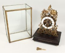 A GOOD BRASS SKELETON CLOCK striking on five bells, the base with a single drawer and glass dome.