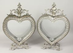 A PAIR OF SILVERED METAL HEART LANTERNS 24ins high.