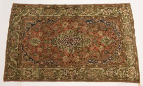 A PERSIAN ISFAHAN RUG, pink ground with all over floral decoration 7ft 2ins x 4ft 5ins.