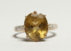 A TOPAZ RING with diamond shoulders