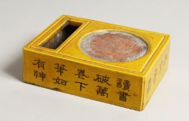 A CHINESE YELLOW PORCELAIN INK STONE with calligraphy. 7.5ins high.