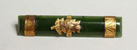 A JADE GOLD MOUNTED BAR BROOCH