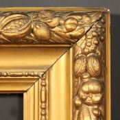 A 19th Century gilt composition frame with a border of trailing vines and fruit, rebate size - 30.5