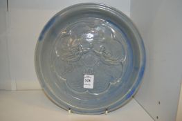 A Chinese Celadon dish with moulded decoration.