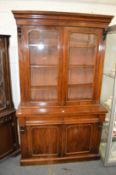 A Victorian walnut cupboard bookcase.