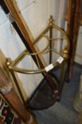 A brass and cast iron demi-lune walking stick stand.