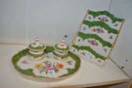 A porcelain desk set comprising a tray with two inkwells and a letter rack, all floral decorated