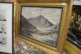 A mountainous landscape with a figure in the foreground, oil on canvas, in a decorative gilt frame.