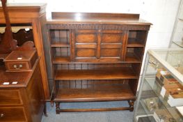 An oak bookcase with drop-flap.