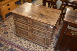 A 17th century oak chest of drawers with three long geometrically moulded drawers.