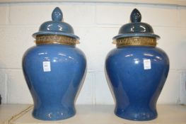 A large pair of Chinese blue glazed temple jars and covers.