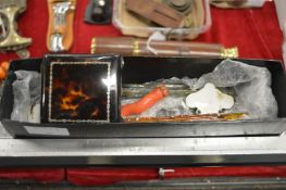 A tortoiseshell compact, cylindrical glass scent bottles and other collectables.