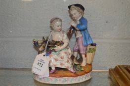 A 19th century porcelain group of a young boy and girl with a goat and grapes.