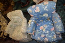 A pair of upholstered small armchairs.