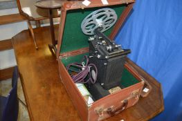 A cased early cine projector.
