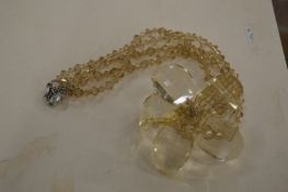 A Butler & Wilson flower head pendant and chain.