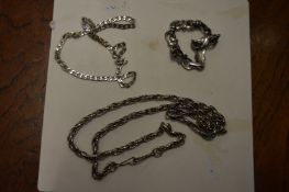 A heavy silver bracelet and similar necklaces.