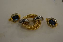 Christian Dior earrings and a decorative brooch.