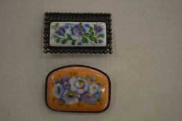 Two decorative brooches.