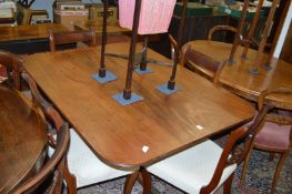 A George III mahogany tilt top breakfast table with rounded rectangular top, turned column support