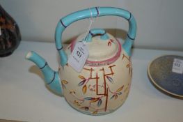A Chinese teapot with faux bamboo handle and spout.