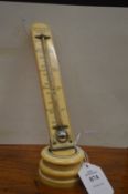 An early 20th century ivory thermometer by Watkins & Hill, London.