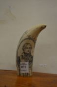 A reproduction scrimshaw tooth.